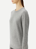 Gray sweater worn by a person on a white background. #color_urban-silver