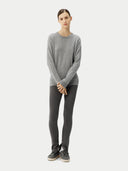 Person wearing a gray sweater and leggings on a white background. #color_urban-silver