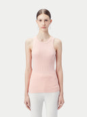 A female model wearing a pink ribbed cotton silk cashmere blend tank top and white pants. #color_primrose-pink