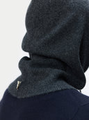 Dark gray knit cowl worn by a person on a light gray background