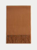An oversized cashmere scarf in brown with fringes at the bottom edge.