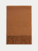 An oversized cashmere scarf in brown with fringes at the bottom edge. #color_golden-brown