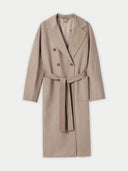 A double breasted long coat in a beige color, with wide notch lapels and a belt at the waist. #color_taupe