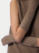 Close-up of a person wearing a ribbed knit sleeveless top with matching ribbed knit elbow-length sleeves in a taupe-brown color. A small brown label on the cuff reads GOBI.