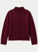 A dark burgundy knit sweater with a high mock neck and a central braided cable detail down the front, displayed on a light gray background.