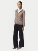 Full-length view of the taupe cashmere zip hoodie styled with wide black trousers