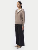 Model in the taupe cashmere zip hoodie, three-quarter side view