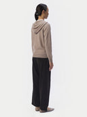 Back view of the taupe cashmere zip hoodie on a model, hood down