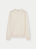 A crew neck cashmere sweater in beige color.