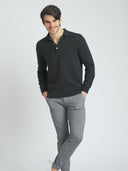 Man wearing a dark gray long-sleeve polo shirt and light gray pants on a white background #color_charcoal