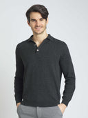 Man wearing a dark gray long-sleeve polo shirt against a light gray background