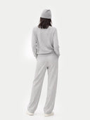 Person wearing a gray outfit with a beanie on a white background