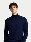 Man wearing a navy turtleneck sweater on a light gray background. #color_dark-indigo #ai-image