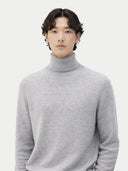 Man wearing a gray turtleneck sweater against a white background #color_vapor-blue