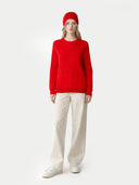 Person wearing a red sweater and pants with a white background #color_hibiscus