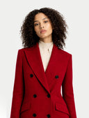 Woman wearing a red coat with black buttons on a white background. #color_bordeaux #ai-image