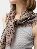 Shop GOBI Cashmere accessories — brown animal-print cashmere scarf draped over the shoulder