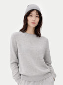 Person wearing a gray sweater and hat on a white background #color_light-gray