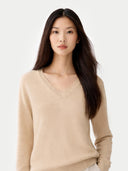 Woman wearing a beige sweater against a white background #color_Beige
