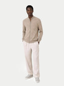 Man wearing a beige zip-up sweater and light-colored pants on a white background #color_taupe