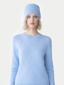 Person wearing a light blue sweater and matching beanie on a white background #color_sky-blue