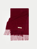 Burgundy scarf with fringes on a light gray background