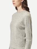 Person wearing a light gray sweater on a white background. #color_steel-silver