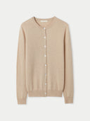 A beige crew neck cashmere cardigan with a round neckline and short sleeves.