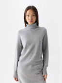Woman wearing a grey roll neck jumper on a white background #color_high-rise
