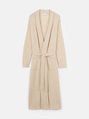 A long-sleeved beige knit bathrobe with a shawl collar, tie belt, and front patch pockets, shown flat against a light gray background. #color_beige