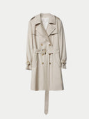 A double-breasted, beige cashmere trench coat with a belt, lapel collar, and front pockets laid out flat on a plain background. #color_warm-grey