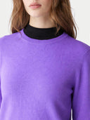 Purple jumper worn by a person with a plain background. #color_purple #ai-image