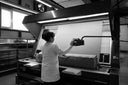 A GOBI technician inspecting a bolt of cashmere fabric on an inspection machine