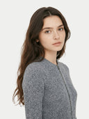 Woman wearing a gray knitted cardigan on a white background