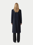 Back view of a woman wearing a long black coat on a white background. #color_black #ai-image