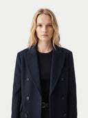 Woman wearing a dark blue coat on a light gray background. #color_black #ai-image