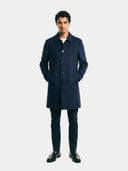 Man wearing a navy blue coat on a white background. #color_navy #ai-image