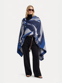 Woman wearing a blue patterned scarf on a white background. #color_white #ai-image