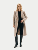 Woman wearing a beige coat and black pants on a white background. #color_taupe #ai-image