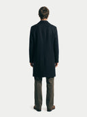 back view of a man wearing a black coat from behind on a white background. #color_black #ai-image