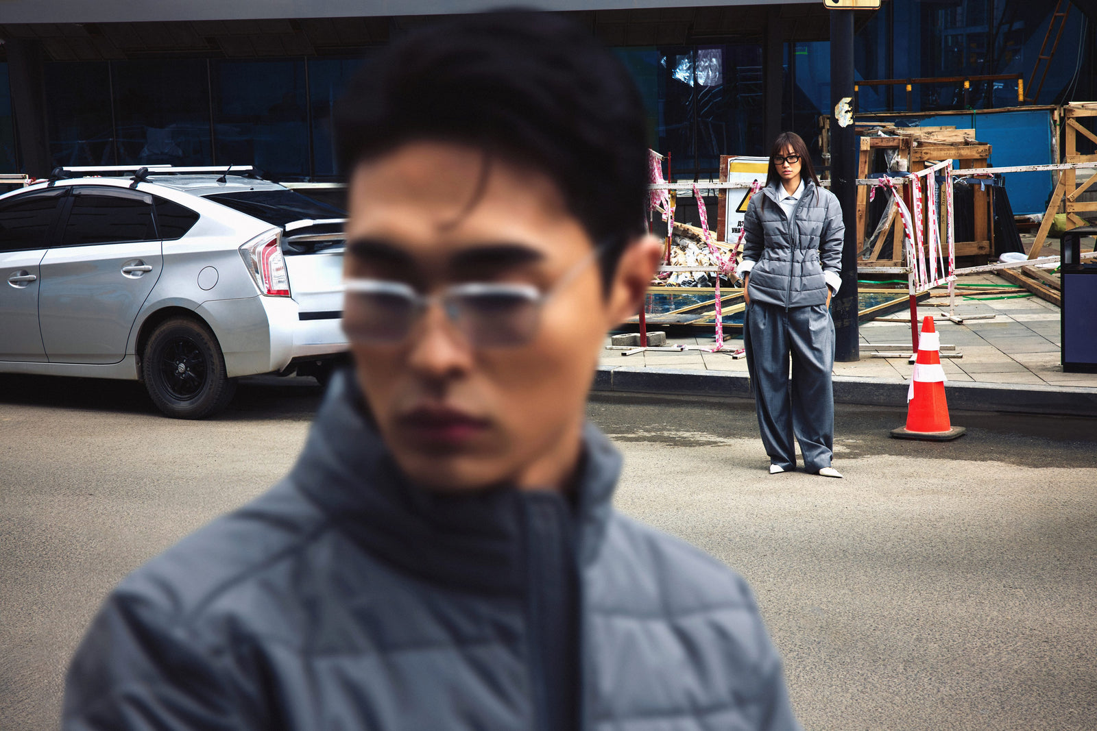 A man in a grey CashmereTech puffer jacket on a city street