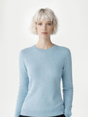 Woman wearing a light blue sweater against a white background #color_cloud-blue