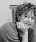 Kathleen Hager resting her chin on her hand, black-and-white portrait