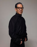 Naoki Takizawa, GOBI Cashmere Design Director, in a black mandarin-collar shirt