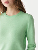 Green sweater worn by a person on a white background. #color_soft-green #ai-image