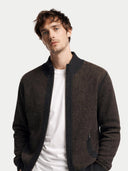 Man wearing a brown jacket over a white shirt on a light gray background. #color_charcoal #ai-image