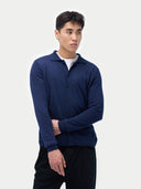 Person wearing a navy blue cardigan on a plain background