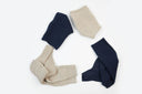 Navy and beige cashmere sleeves arranged in a triangle on white — CashmeReborn remnants