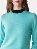 Teal jumper worn by a person on a white background. #color_aqua-green #ai-image