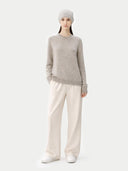 Person wearing a gray sweater and white pants on a white background #color_dawn-blue